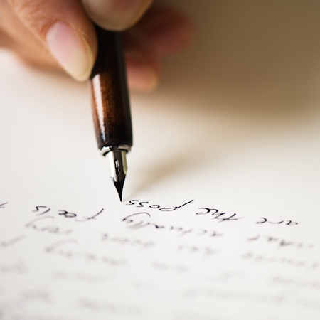 Picture of a hand writing a letter with a fountain pen